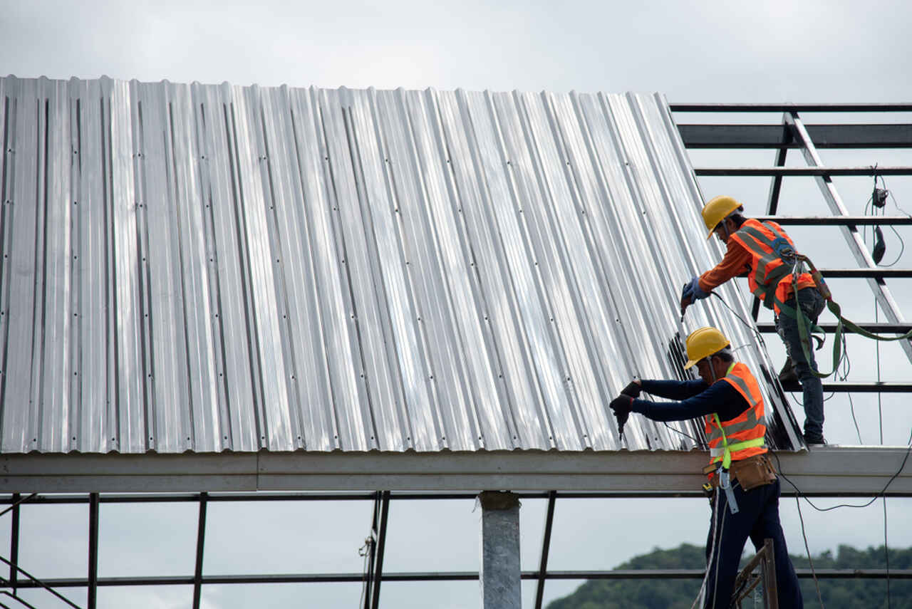 sheet metal application by two workers